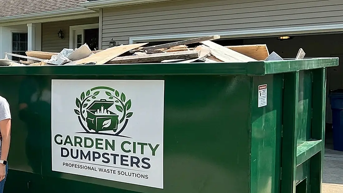A roll-off container loaded level with renovation and construction debris